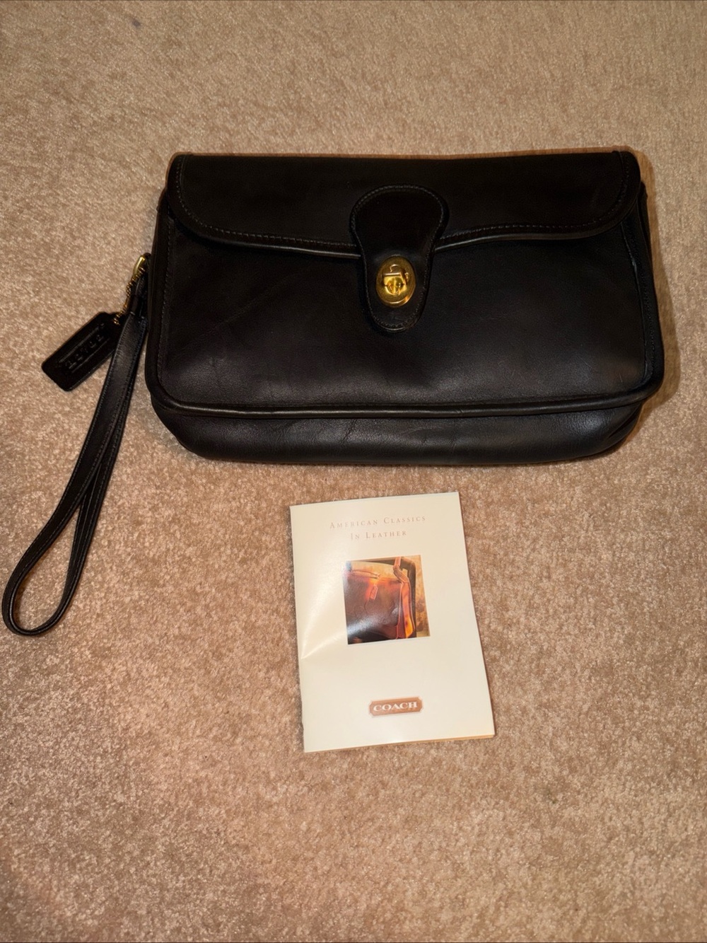 NWOT vintage black leather Coach wristlet features a classic a detachable strap
